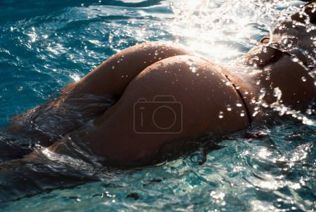 Téléchargez les photos : Sexy summer relaxing. Beautiful sexy lady in bikini. Luxury butt. Sensual seductive young girl in swimming pool. Summer beach - en image libre de droit