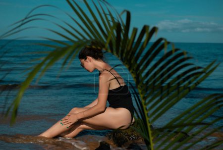 Photo for Woman resting on the sea coast. Tropical vacation paradise with white sandy beaches and palm trees - Royalty Free Image