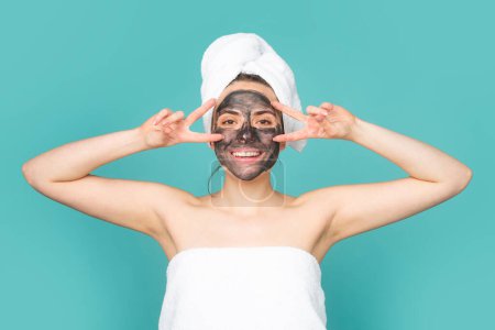 Photo for Close up beauty portrait of a beautiful woman with facial mud mask. Mask for skin lifting and anti-aging effect, studio background. Anti aging cream. Facial treatment - Royalty Free Image