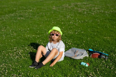 Photo for Kids relaxation. Child go for a walk in the park. Summer holiday activitie. Kid boy are relaxing outdoor. Child playing in the garden. Healthy lifestyle concept - Royalty Free Image