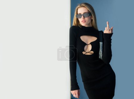 Photo for Fashion outdoor photo of beautiful fashion model with fuck off, middle finger gesture. Young beautiful sensual girl in trendy summer clothes - Royalty Free Image