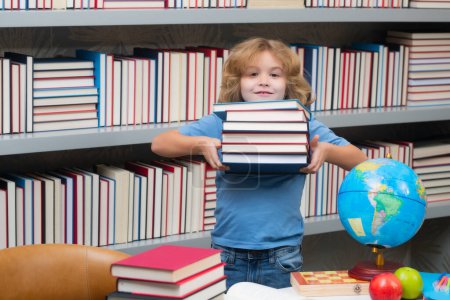 Photo for School boy with stack of books in library. Little student school child. Portrait of nerd student with school supplies - Royalty Free Image