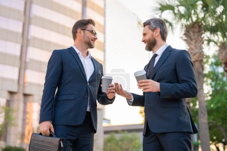 Photo for Business communication. Two business men talking on coffee break outdoors. Two diverse businessmen talking together. Colleagues discussing and thinking about project. Talking between two business men - Royalty Free Image