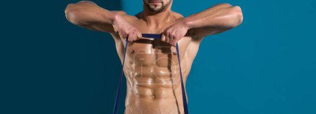 Photo for Workout of man with muscular body workout with expander gripper. Banner templates with muscular man, muscular torso, six pack abs muscle. Muscle body of strong man - Royalty Free Image