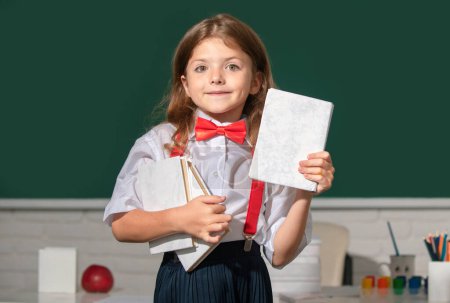 Photo for Cute little child studying in classroom at elementary school. Genius child, knowledge day - Royalty Free Image