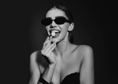 Photo for Portrait of sexy girl. Young glamour sexy girl in sunglasses with lollipop looking at the camera - Royalty Free Image
