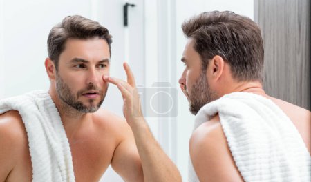 Photo for Male beauty cosmetics, beauty and skincare. Morning healthcare and hygiene for man. Perfect beauty skin. Handsome millennial man after shower apply nourishing facial cream or mask on skin - Royalty Free Image