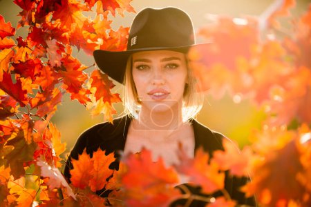 Photo for Autumn romance woman with leaves. Female model on foliage day. Dream and lifestyle. Beauty outdoor portrait. Carefree gorgeous sensual natural tender charming girl with leaf on face. Fall nature - Royalty Free Image