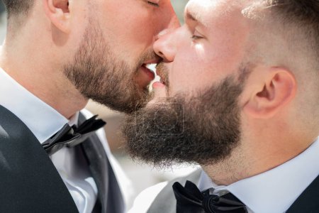 Gay kiss on wedding. Marriage gay couple tender kissing. Close up portrait of gay kissed. Portrait of happy gay couple on their wedding day outdoor