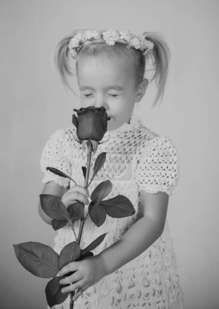 Photo for Love present. childrens day. small kid with red rose. happy childhood. valentines day. romantic date. little girl in vintage dress. Beauty. retro style. happy birthday. wedding. what great a smell. - Royalty Free Image