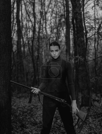 Photo for Female hunter in forest. successful hunt. hunting sport. military fashion. achievements of goals. girl with rifle. chase hunting. Gun shop. woman with weapon. Target shot. hunter aiming rifle nature. - Royalty Free Image