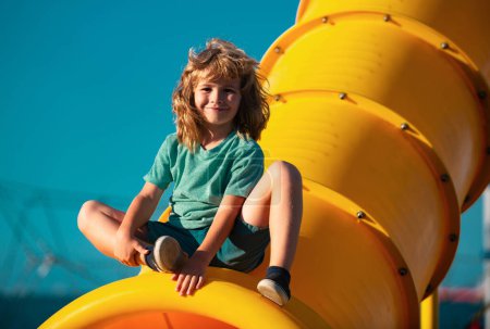 Photo for Joyful kid boy having fun on playground outdoors. Funny kids face - Royalty Free Image