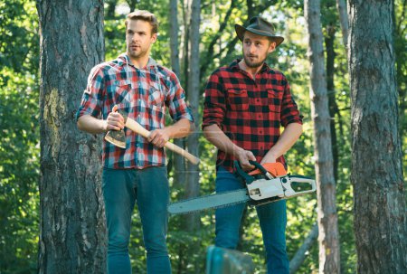 Photo for Man woodcutter holding ax. Axe in lumberjack hands cutting wood. Lumberman with a chainsaw in forest. Concept of a professional logging woodcut. Forest workers - Royalty Free Image
