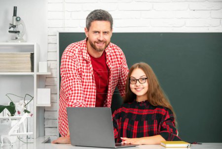 Photo for School child learning education online lesson. Elementary school teacher and pupil in classroom - Royalty Free Image