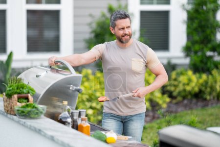 Photo for BBQ, grilling, barbecue outside. Man with barbeque roast fish outdoor. Grilling and barbecue concept. Bbq and grill. Man in barbecue preparing fish salmon. Chef cooking barbecuing seafood - Royalty Free Image