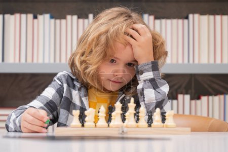 Photo for Play chess. Clever child thinking about chess. Kids early development - Royalty Free Image