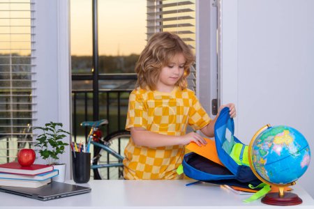 Photo for Preparation for school. Smart caucasian school boy kid pupil student going back to school. Little student kid preparing school homework. Child involved in doing task, studying homeschooling - Royalty Free Image
