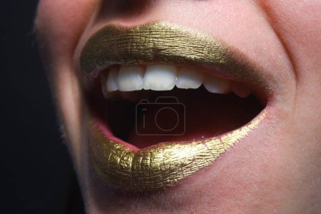 Photo for Gold lips. Gold paint on mouth. Golden lips. Luxury gold lips make-up. Golden lips with creative metallic lipstick. Gold metal lip. Sensual woman mouth, clse up, macro - Royalty Free Image