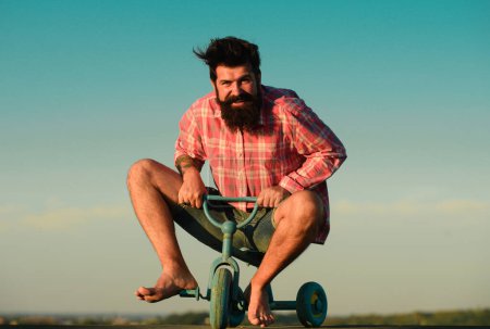 Photo for Funny hipster man riding a small bicycle - Royalty Free Image