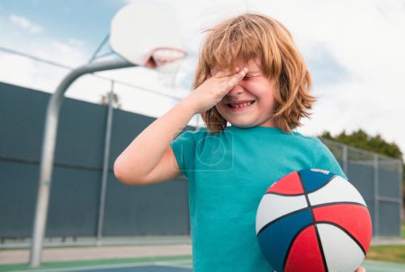 Photo for Little boy alone, lonely with ball. Loneliness kids. Boy cries of resentment and grief. Sad child boy portrait - Royalty Free Image