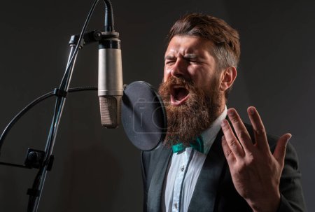 Photo for Classical music. Handsome man in recording studio. Music performance vocal. Singer singing song with a microphone - Royalty Free Image