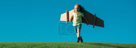 Photo for Banner with spring kids portrait. Child boy playing pilot on the sky blue background. Kid dreaming. Child playing with toy jetpack. Kid pilot having fun at park - Royalty Free Image