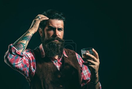 Photo for Retro vintage man with whiskey or scotch. Tasting and degustation concept. Man Bartender with beard holds glass brandy. Luxury beverage concept - Royalty Free Image