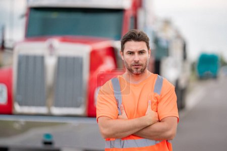 Photo for Men driver near lorry truck. Man owner truck driver in safety vest near truck. Handsome middle aged man trucker trucking owner. Semi trailer, semi trucks. Handsome man posing in front of truck - Royalty Free Image
