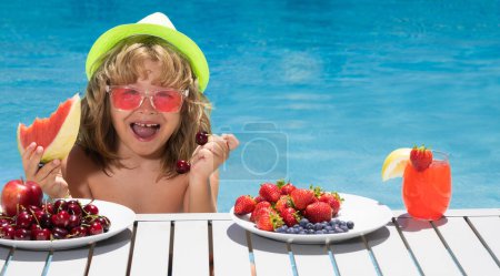 Photo for Excited child in swimming pool. Kids swim on summer vacation. Kid relaxing on sea beach or pool. Beach sea and water fun. Summer kids cocktail and fruits. Funny amazed kids face - Royalty Free Image