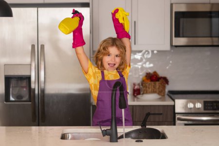 Photo for Child doing housework. Cute kid help in washing dishes at kitchen. Kid cleaning of kithen help with housework. Cute child boy housekeeping, child clean house - Royalty Free Image