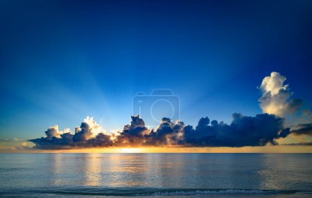 Photo for Clouds on sea sunset, sunrise. Sunset sea landscape. Colorful beach sunrise with calm waves. Nature sea sky. Sunrise with clouds of different colors against the blue sky and sea - Royalty Free Image
