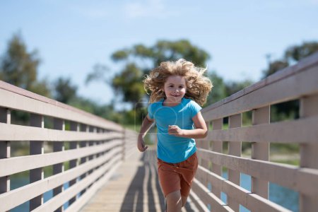 Photo for Sporty kid running in nature. Active healthy child boy runner run outdoor - Royalty Free Image