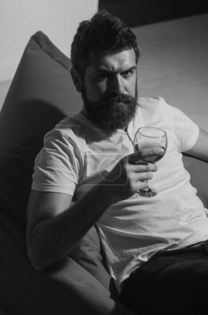 Téléchargez les photos : Celebrate alone. Bearded man with wine. Home alone party. Hipster with alcohol - en image libre de droit