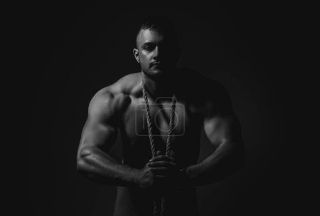 Photo for Muscular shoulders. Masculinity, power and strength. Bare torso man, male abs and body. Healthy muscular young man with rope - Royalty Free Image
