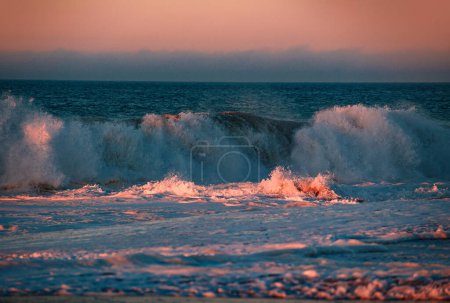 Photo for Beach sunrise over the tropical sea. Colorful sunset with wave splashes on the beach. Ocean waves background - Royalty Free Image