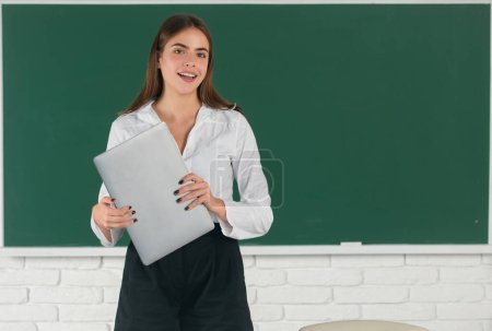 Photo for Portrait of female university student holding laptop at school or university. Girl student with pc technology, distance learning - Royalty Free Image