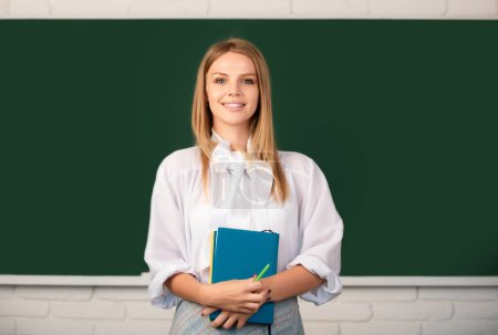 Photo for Student holding book, preparing exam and learning lessons in school classroom - Royalty Free Image