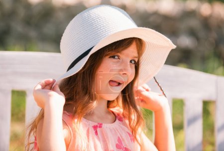 Photo for Funny kids face with tongue. Portrait of funny child girl in summer park. Face close up of cute teen girl outdoor. Cute little girl swinging on the meadow in summer day - Royalty Free Image
