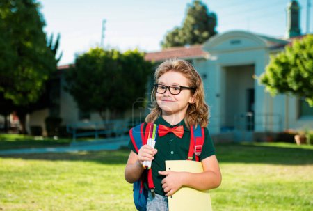Photo for School, kids education concept. Child with rucksacks standing in the school park. Pupil with backpacks outdoors - Royalty Free Image