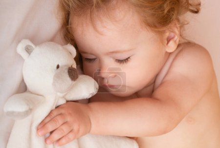 Photo for Baby sleeping in the bed. Quiet sleep with teddy bear - Royalty Free Image