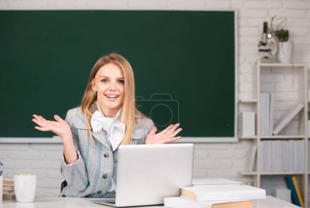 Photo for Portrait of young female college student studying in classroom on class on blackboard background - Royalty Free Image