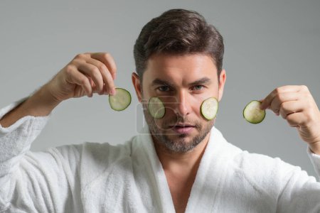 Photo for Beauty man with cucumber mask. Cucumber for cosmetics skin mask. Facial mask with cucumber. Spa, dermatology, wellness and facial treatment concept. Male cosmetic mask with cucumber - Royalty Free Image