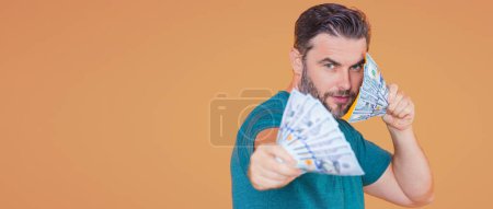 Photo for Successful man counting money. Handsome middle age man holding bunch of 100 dollar banknotes. Guy holding money cash. Business man with dollar cash - Royalty Free Image