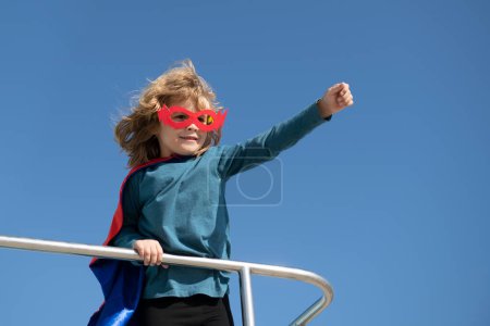 Photo for Portrait of superhero kid against blue sky background. Copy space. Child superhero - Royalty Free Image
