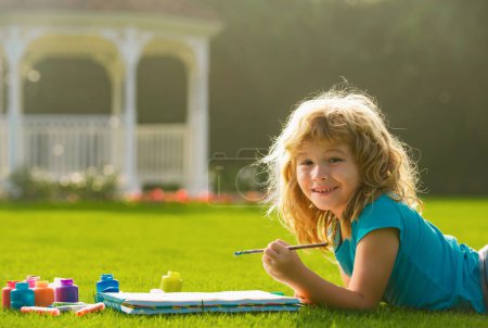 Photo for Children draw paint pictures outside, childrens creativity. Child boy drawing in summer park, painting art. Little artist painter draw pictures outdoor - Royalty Free Image