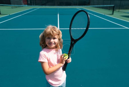 Photo for Child boy tennis beginner player on outdoor tennis court - Royalty Free Image