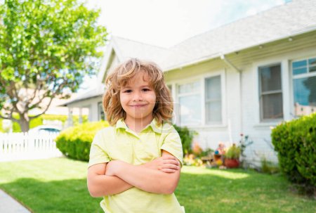 Photo for Kids with funny face on the backyard lawn. Sweet little boy outdoors portrait - Royalty Free Image