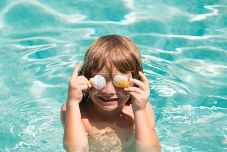Photo for Happy child having fun at swimming pool on summer day. Children playing in blue sea water. Funny kids face. Covered eyes with shells - Royalty Free Image