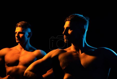 Photo for Fitness models and young bodybuilders. Posing chest. Concept of power and healthcare, black background - Royalty Free Image