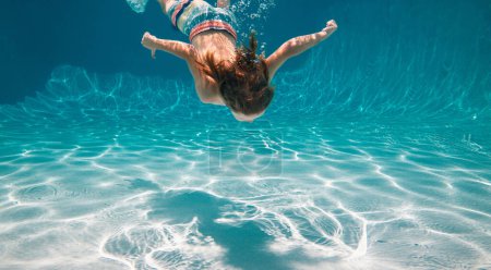 Téléchargez les photos : Un gamin qui nage sous l'eau. Vacances d'été avec les enfants dans une station tropicale. Enfant sous l'eau - en image libre de droit